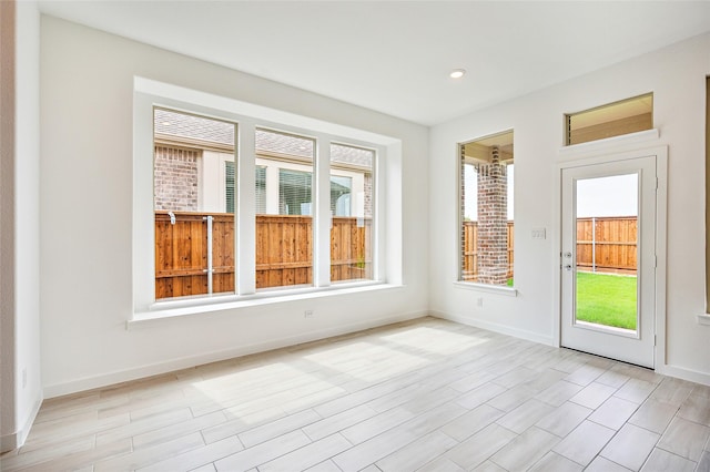 unfurnished sunroom with plenty of natural light