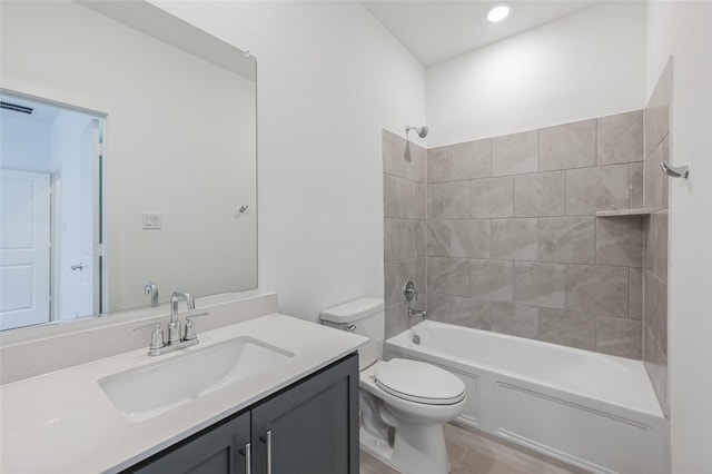 full bathroom with toilet, tiled shower / bath combo, and vanity