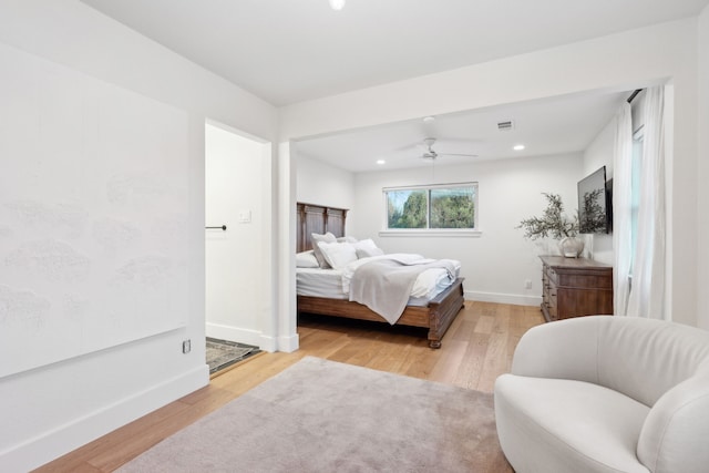 bedroom with ceiling fan and light hardwood / wood-style flooring