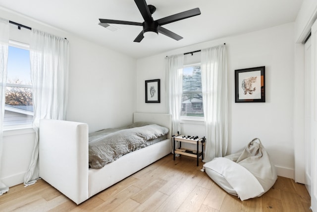 bedroom with hardwood / wood-style floors and ceiling fan