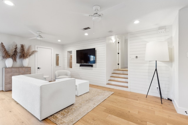 living room featuring hardwood / wood-style flooring and ceiling fan