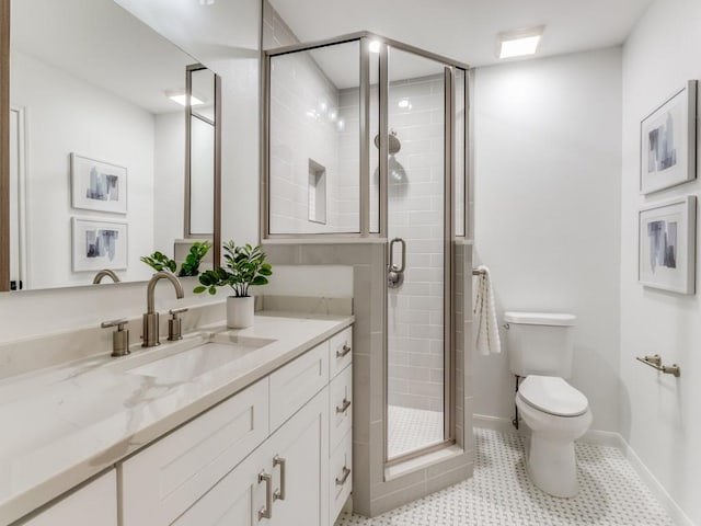 bathroom with tile patterned floors, toilet, vanity, and a shower with shower door