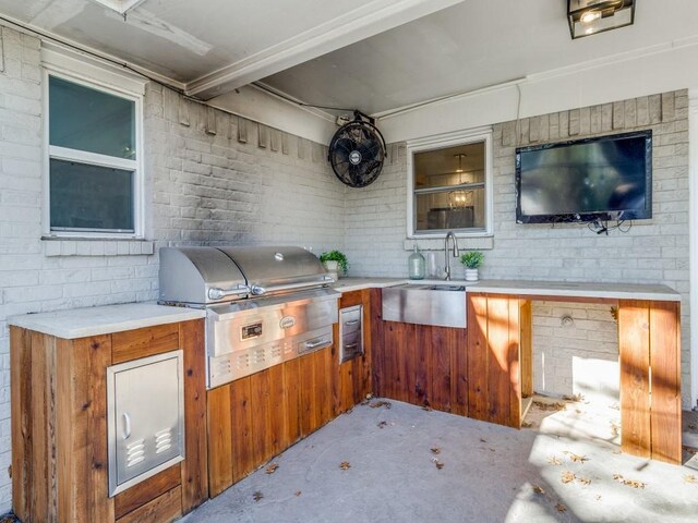 view of patio with sink, an outdoor kitchen, and area for grilling