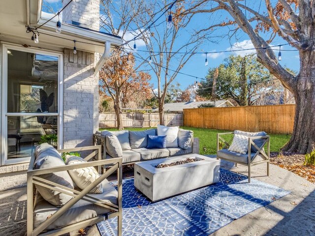 view of patio featuring an outdoor living space with a fire pit