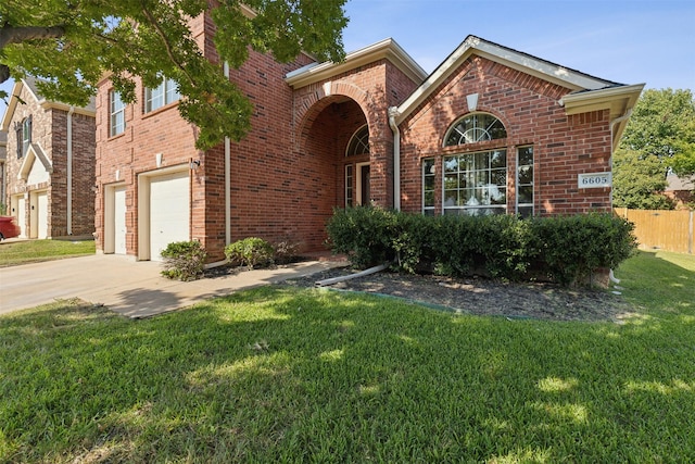 view of front of house featuring a garage and a front lawn