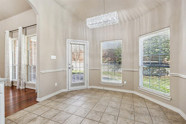 unfurnished room featuring lofted ceiling and light carpet