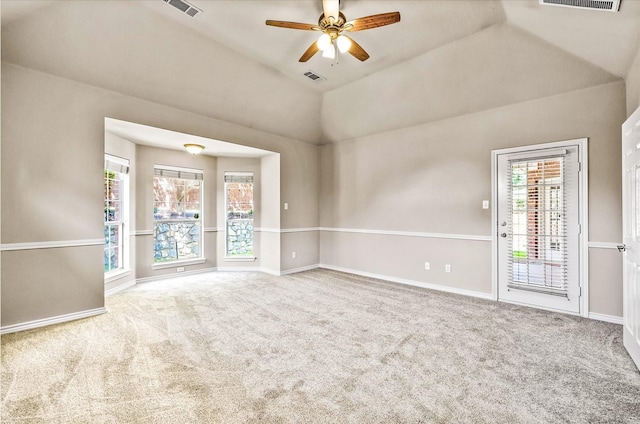 empty room with lofted ceiling, ceiling fan, and carpet