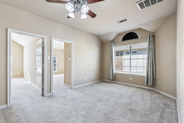 carpeted empty room with lofted ceiling and ceiling fan