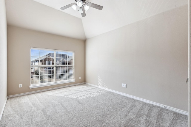 spare room featuring ceiling fan, light carpet, and lofted ceiling