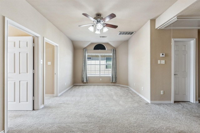 carpeted empty room featuring lofted ceiling and ceiling fan