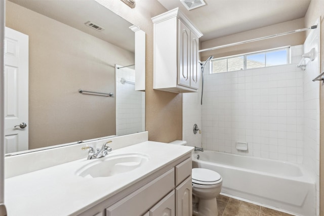 full bathroom with toilet, tile patterned flooring, tiled shower / bath, and vanity