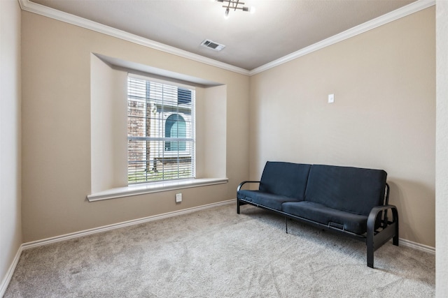 sitting room with ornamental molding and carpet