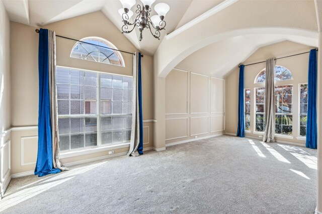 unfurnished living room with dark hardwood / wood-style flooring, a stone fireplace, high vaulted ceiling, and a chandelier