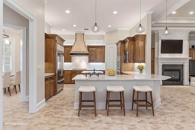 kitchen with built in appliances, a kitchen bar, tasteful backsplash, and premium range hood