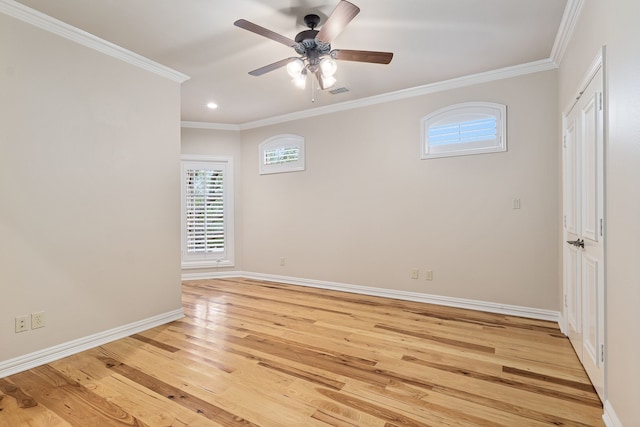 spare room featuring ceiling fan, light wood-type flooring, and crown molding