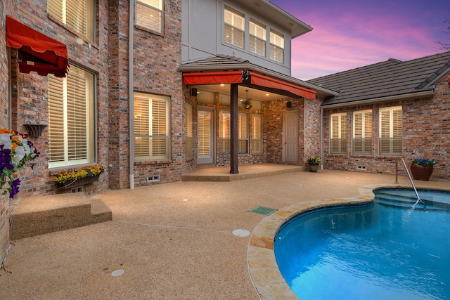 pool at dusk featuring a patio area