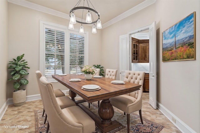 dining room with a chandelier and crown molding