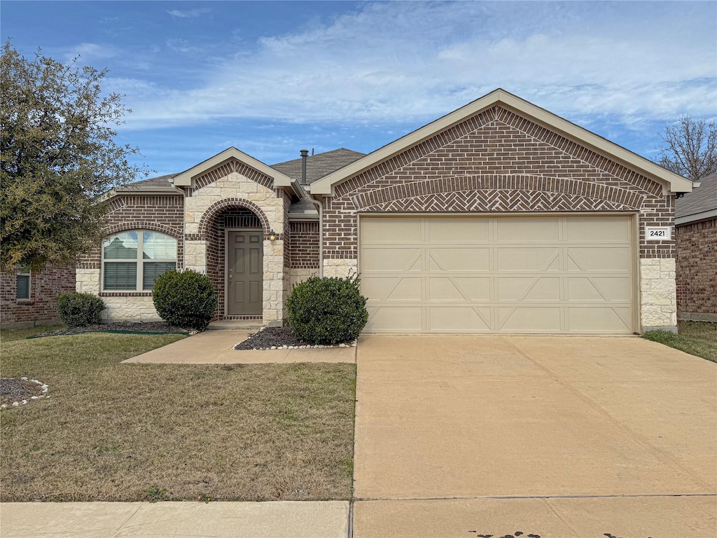 view of front facade with a front yard and a garage