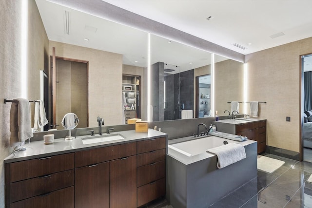 bathroom featuring walk in shower, vanity, and tile patterned floors