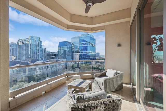 balcony featuring a ceiling fan and a city view