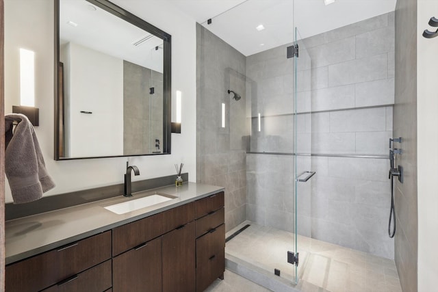 bathroom featuring walk in shower and vanity