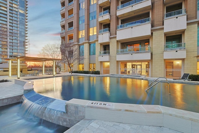 view of pool at dusk