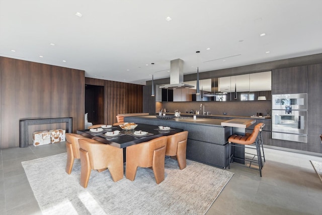 dining space featuring sink and wood walls