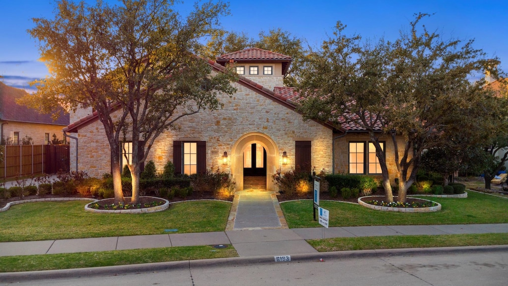 mediterranean / spanish house with a yard