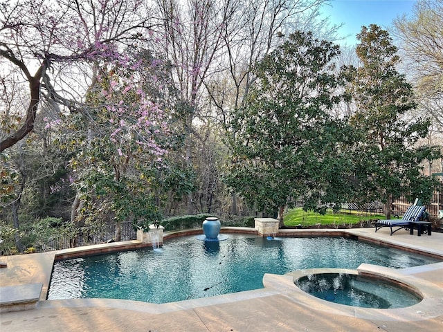 view of pool with an in ground hot tub