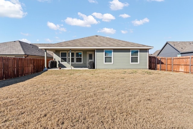 rear view of property with a yard