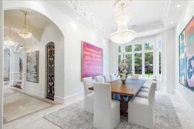 dining space featuring a towering ceiling and a chandelier