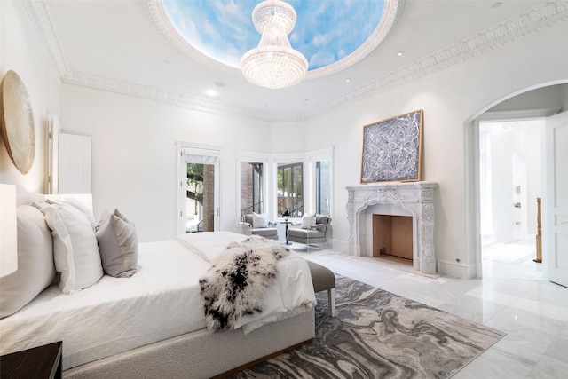 bedroom with a towering ceiling, ornamental molding, and a notable chandelier