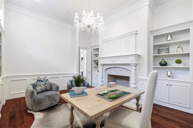 dining area featuring dark hardwood / wood-style floors, built in features, crown molding, and a fireplace