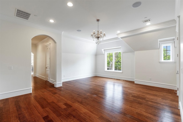 unfurnished room featuring crown molding, a chandelier, lofted ceiling, and dark hardwood / wood-style floors