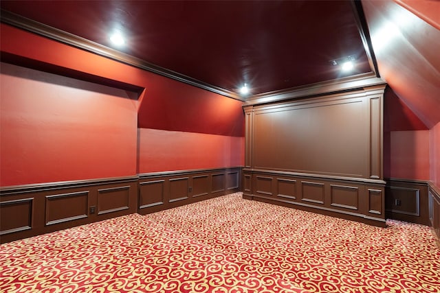 carpeted home theater room with ornamental molding