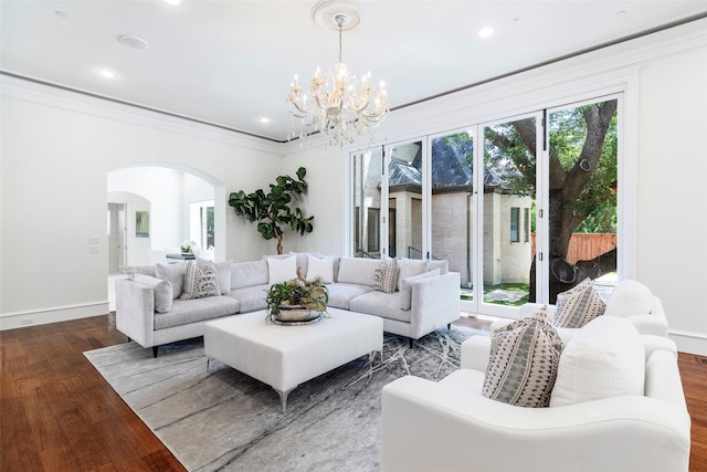 living room with ornamental molding, hardwood / wood-style floors, and a chandelier