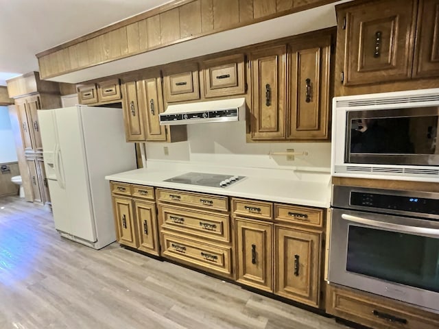 kitchen featuring stainless steel appliances and light hardwood / wood-style flooring