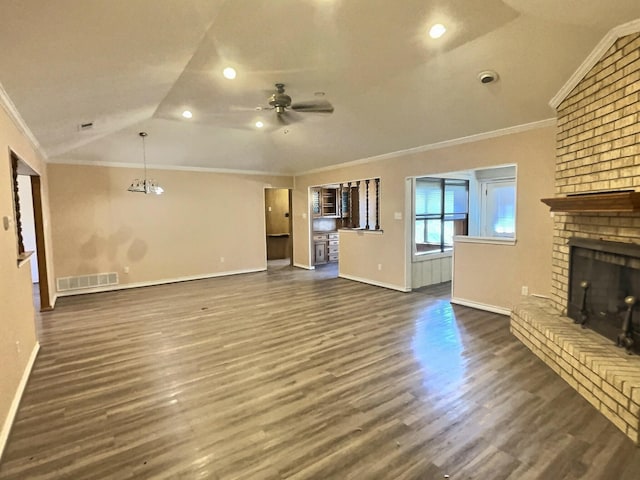 unfurnished living room featuring a fireplace, vaulted ceiling, crown molding, and dark hardwood / wood-style floors