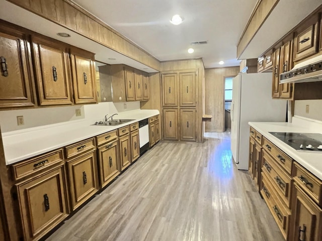 kitchen with sink, dishwashing machine, black electric stovetop, and light hardwood / wood-style floors