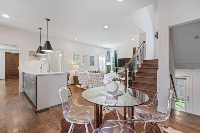 dining area featuring sink and hardwood / wood-style flooring