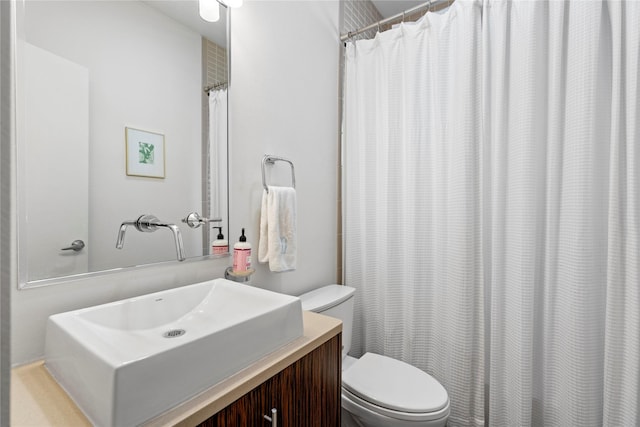 bathroom with toilet and vanity