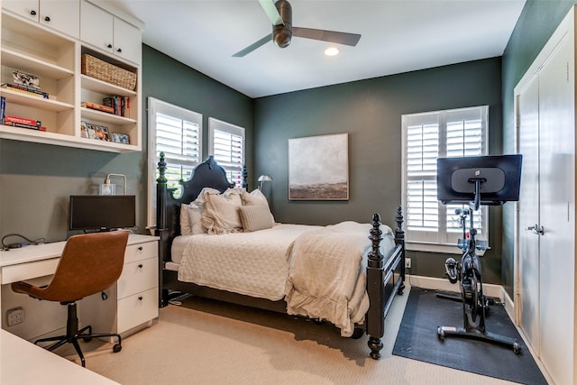 bedroom with ceiling fan and multiple windows