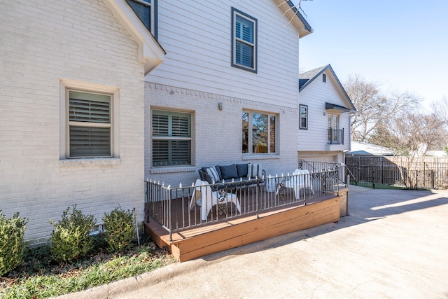 rear view of property with an outdoor hangout area and a wooden deck