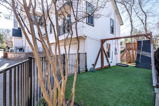 view of yard with a playground and a garage