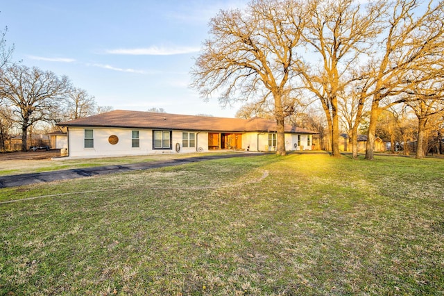 rear view of property with a lawn