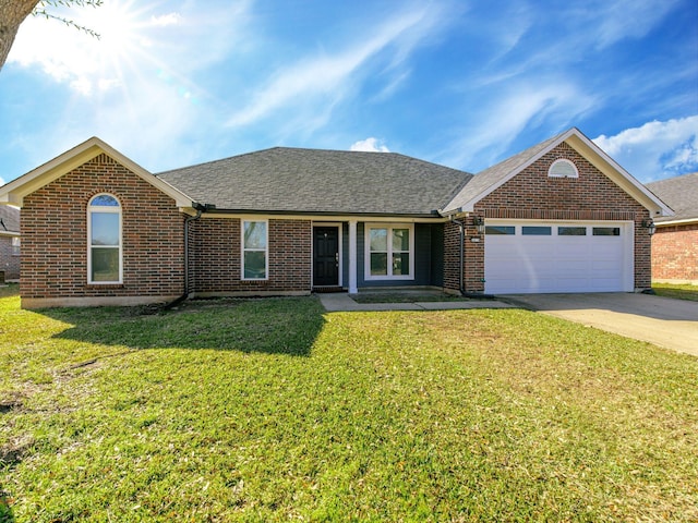 view of front of home with a garage and a front yard