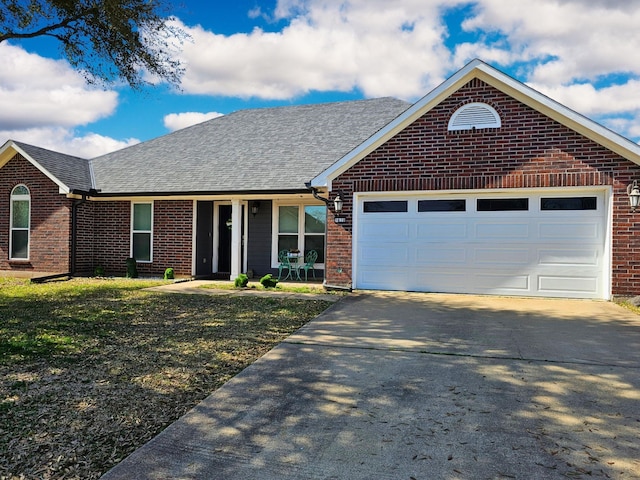 ranch-style house featuring concrete driveway, an attached garage, brick siding, and a shingled roof