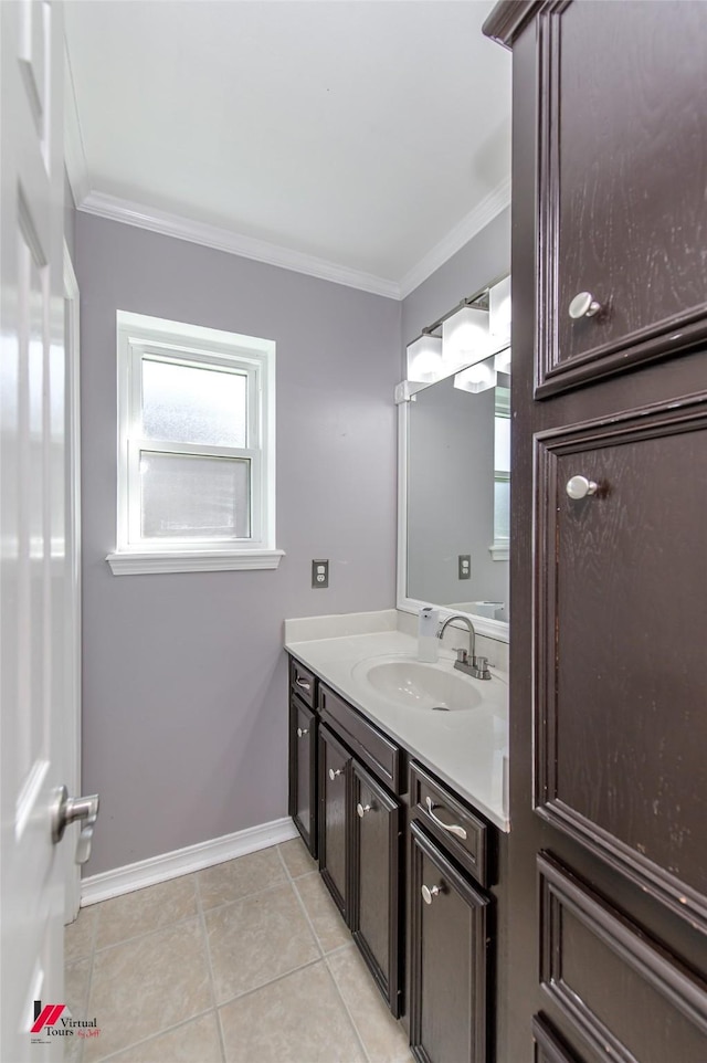 bathroom with baseboards, ornamental molding, vanity, and tile patterned flooring