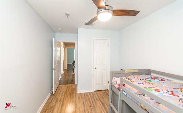 bedroom featuring visible vents, baseboards, a ceiling fan, and light wood finished floors