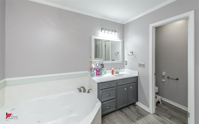 bathroom with vanity, a tub with jets, wood tiled floor, ornamental molding, and toilet